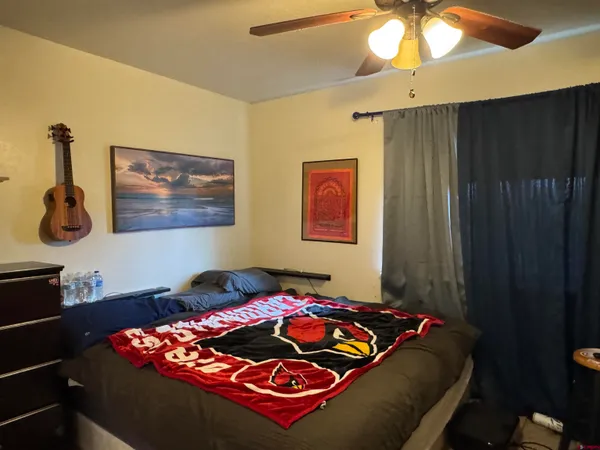a bedroom with bed and a chandelier