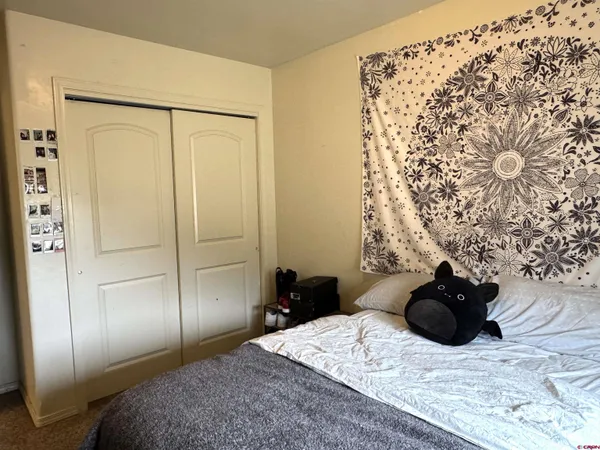 a bedroom with a bed window and wall painting