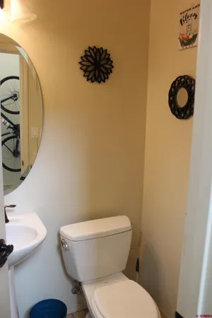 a white toilet sitting next to a bathroom and sink