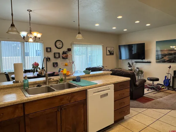a kitchen with a sink a counter space appliances and cabinets