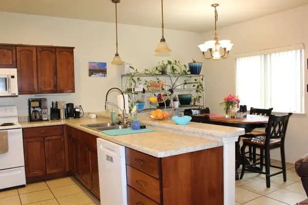 a kitchen with a sink a stove and chairs