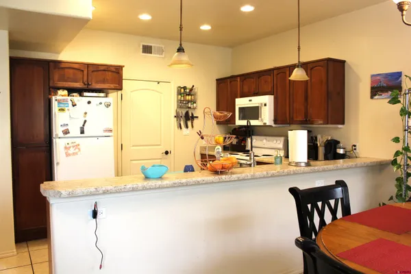 a kitchen with stainless steel appliances granite countertop a sink refrigerator and microwave