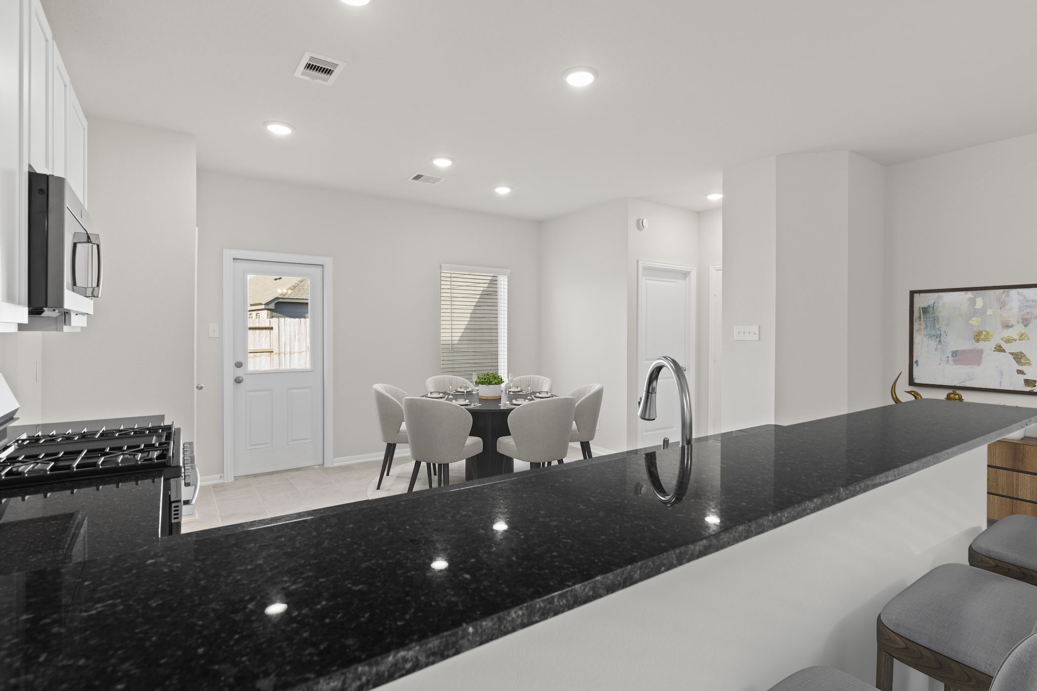 22218 Rome Breeze Drive Hockley, TX 77447 - Photo 13 of 34 The virtually staged kitchen view shows a perfect balance of elegance and practicality. Granite countertops, stainless-steel appliances, and a breakfast bar create a beautiful yet functional space for cooking and entertaining.