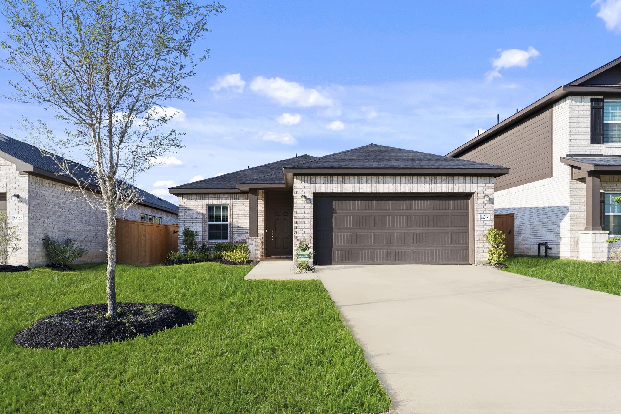 22218 Rome Breeze Drive Hockley, TX 77447 - Photo 2 of 34 Welcome home to this charming brick elevation that exudes timeless appeal! The manicured front lawn and clean lines create a picture-perfect first impression, setting the tone for the beautiful interiors that await inside.