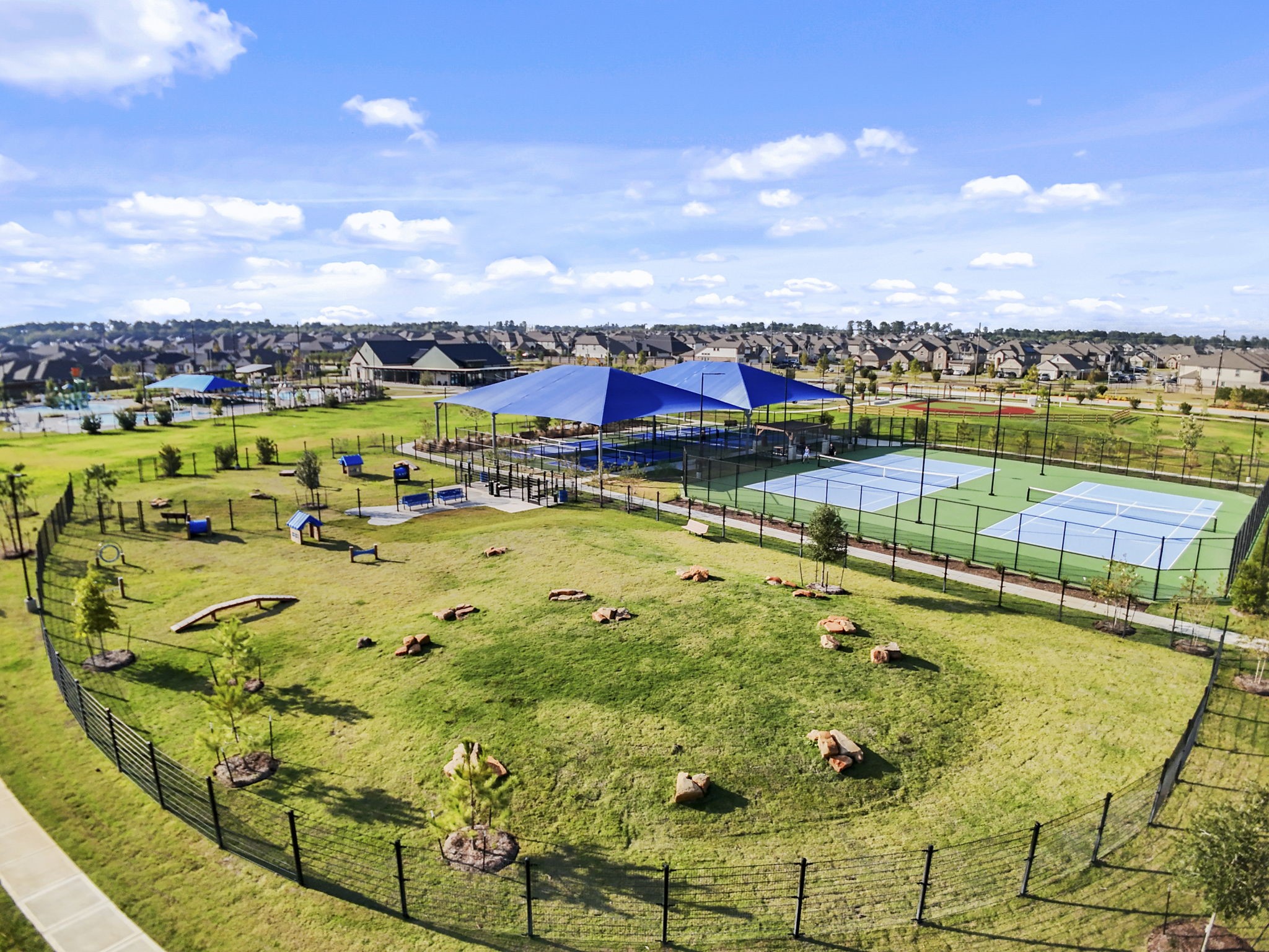 22218 Rome Breeze Drive Hockley, TX 77447 - Photo 29 of 34 Expansive green spaces and well-maintained walking paths create a relaxing environment for residents to enjoy nature, outdoor activities, and picnics with loved ones.
