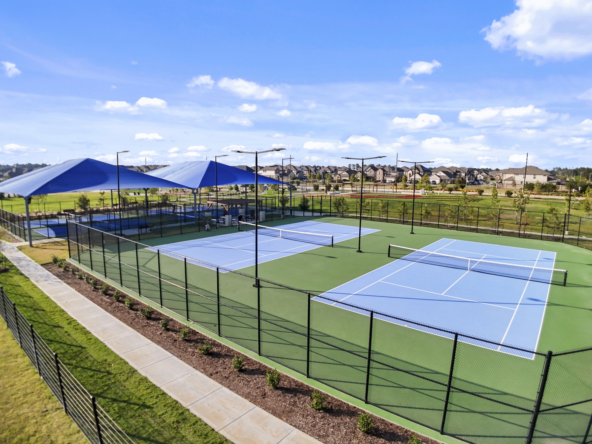 22218 Rome Breeze Drive Hockley, TX 77447 - Photo 30 of 34 Enjoy active living with well-lit tennis and pickleball courts designed for fun, exercise, and community connection. A great spot to stay fit and socialize with neighbors.