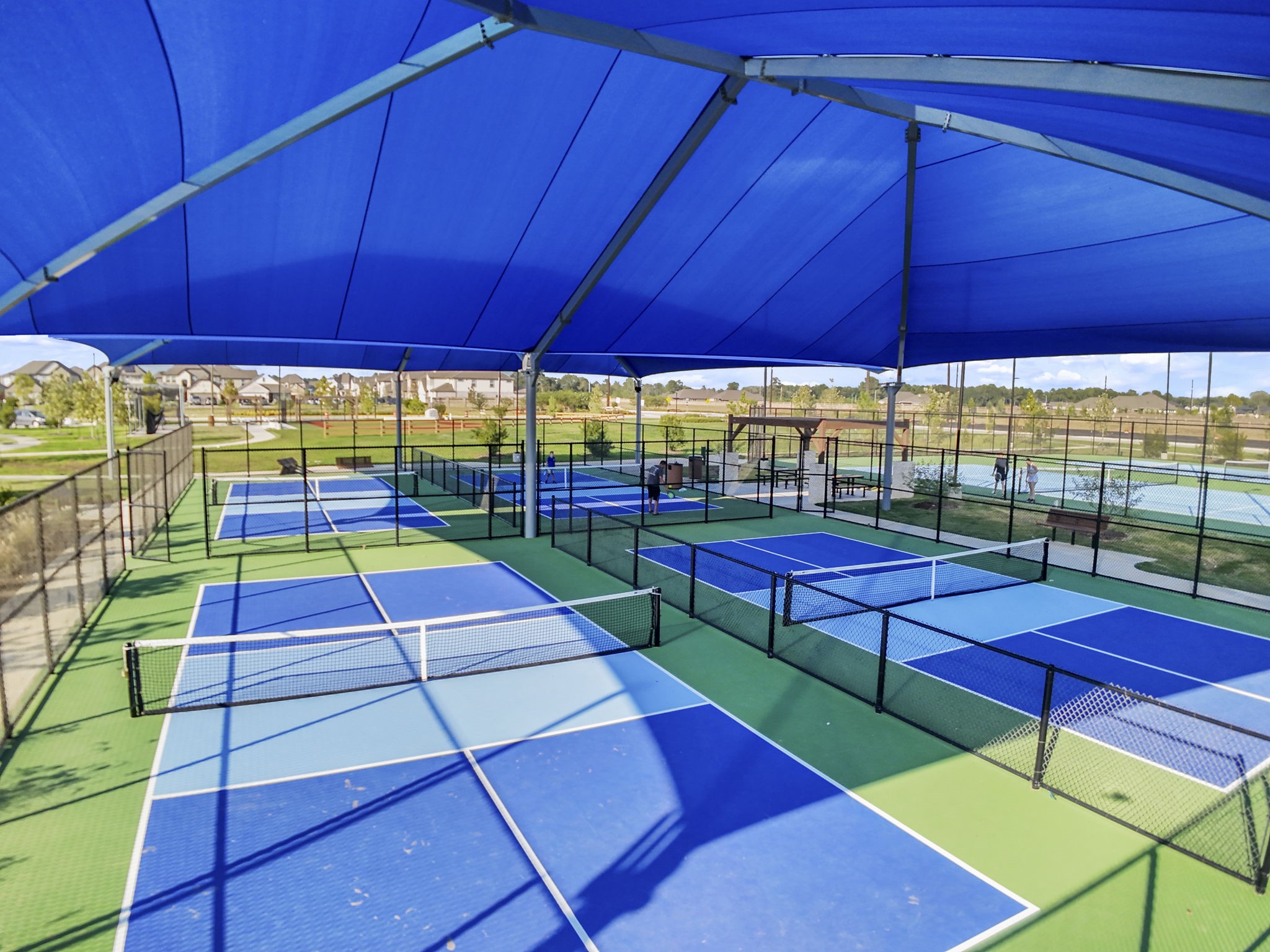 22218 Rome Breeze Drive Hockley, TX 77447 - Photo 31 of 34 Another view of the community courts highlights the shaded seating and well-maintained surfaces, perfect for both casual play and organized games. This amenity adds a wonderful outdoor lifestyle element to the community.