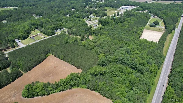 an aerial view of a house with a yard and lake view