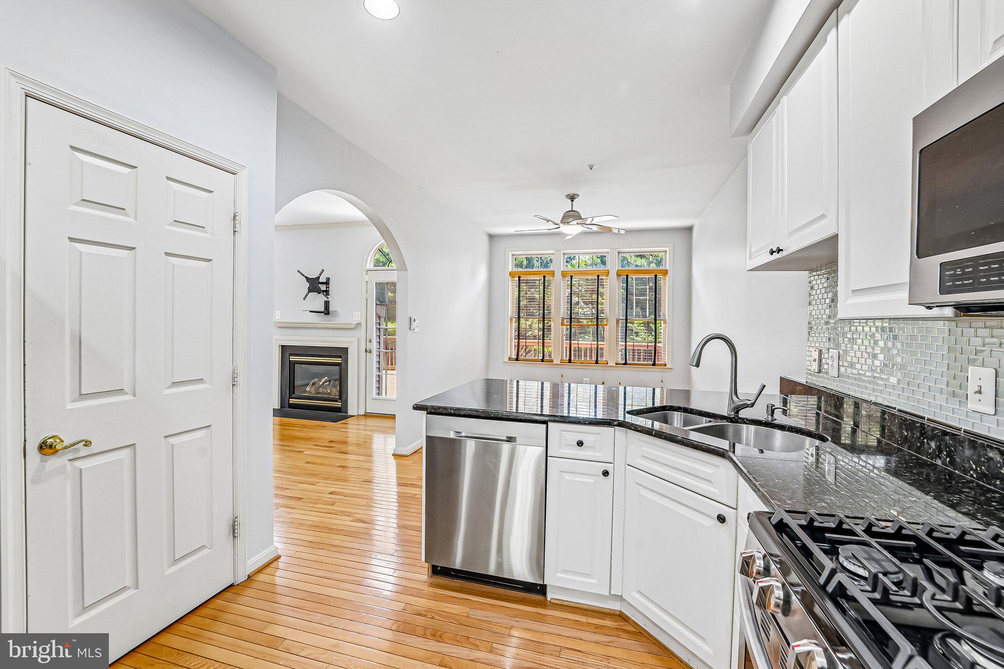 2422 Rippling Brook Road Frederick, MD 21701 - Photo 11 of 35 a kitchen with granite countertop a sink stove and cabinets