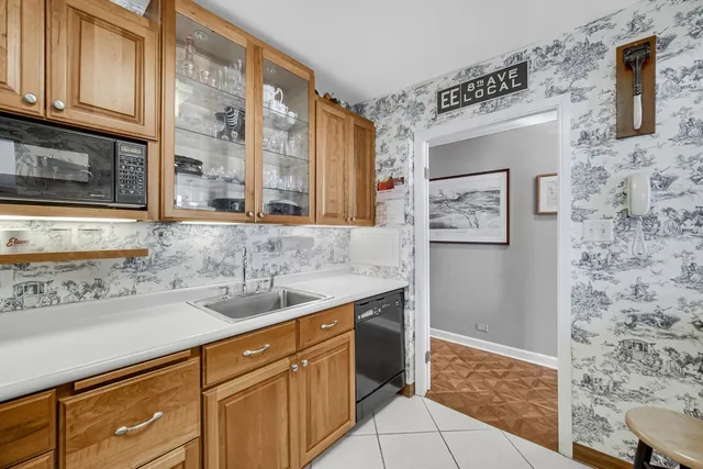 a kitchen with stainless steel appliances granite countertop a sink and a granite counter tops with a wooden floor