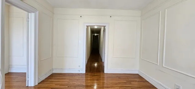 a view of hallway with wooden floor
