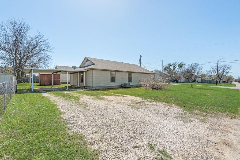 301 Lipscomb Street Cleburne, TX 76031 - Photo 18 of 21 a front view of house with yard and green space