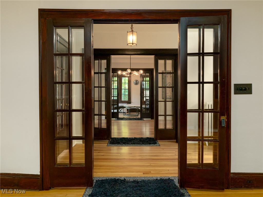 2624 Lee Road Cleveland, OH 44118 - Photo 4 of 50 view across first floor with 3 french doors, an antique chandelier, and refinished white oak hardwood floors