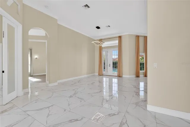 a kitchen with granite countertop a refrigerator sink and cabinets