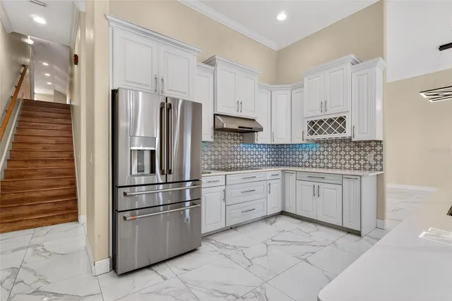 a kitchen with stainless steel appliances a sink and a refrigerator