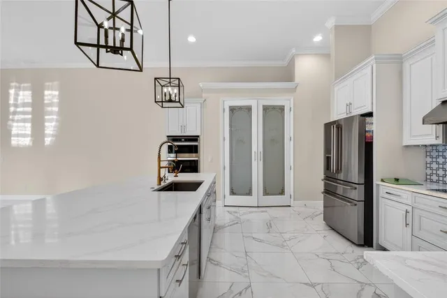 a kitchen with granite countertop a stove and a sink