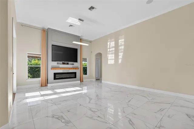 a large white kitchen with a large window and stainless steel appliances