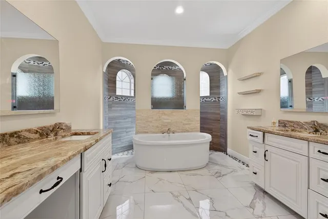 a spacious bathroom with a granite countertop sink and a mirror
