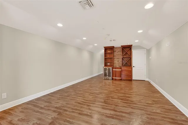 a kitchen with a refrigerator and a stove top oven