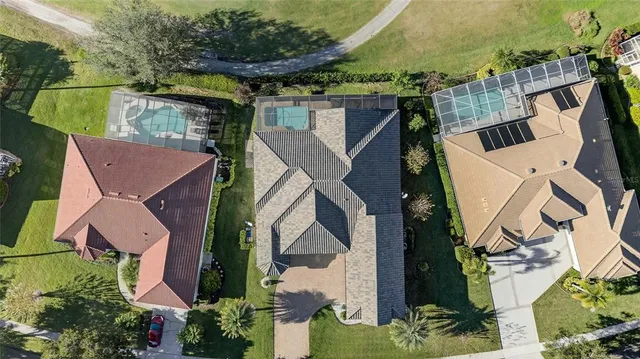 an aerial view of multiple houses with yard
