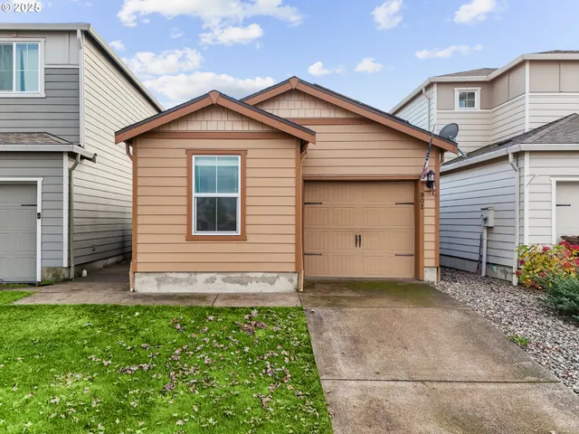 a view of a house with a yard and garage