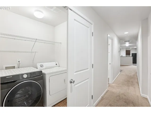 a view of a hallway with washer and dryer