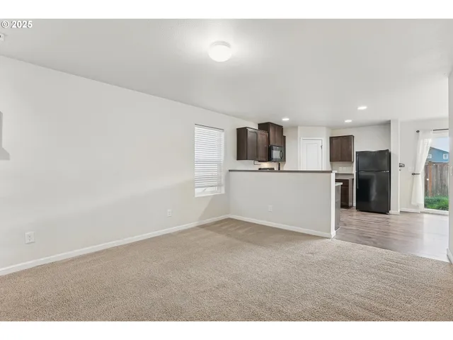 a view of a kitchen with a microwave and white cabinets