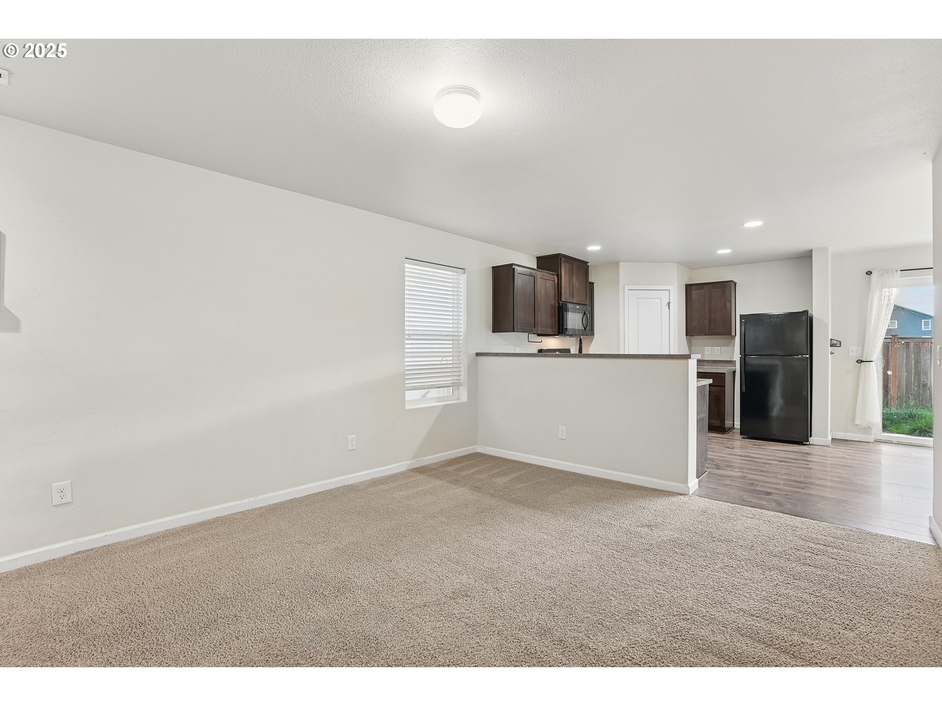 902 South View Drive Molalla, OR 97038 - Photo 6 of 24 a view of a kitchen with a microwave and white cabinets