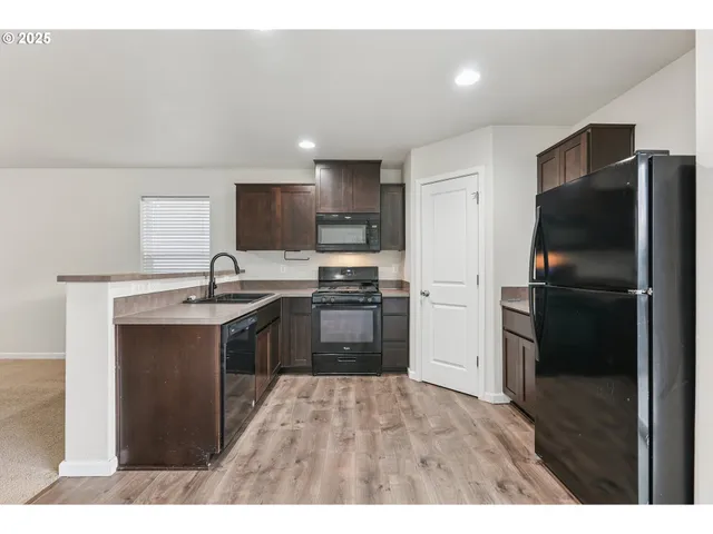 a kitchen with a refrigerator and a sink