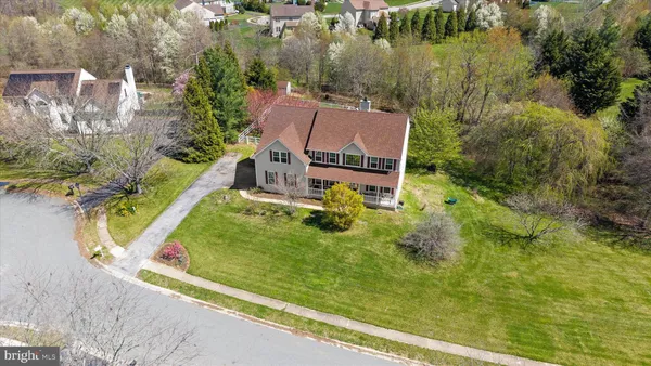 an aerial view of residential house with outdoor space and swimming pool