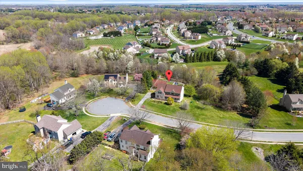 an aerial view of a house with a garden and swimming pool
