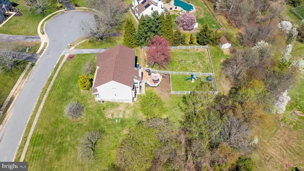 an aerial view of residential house with outdoor space and swimming pool