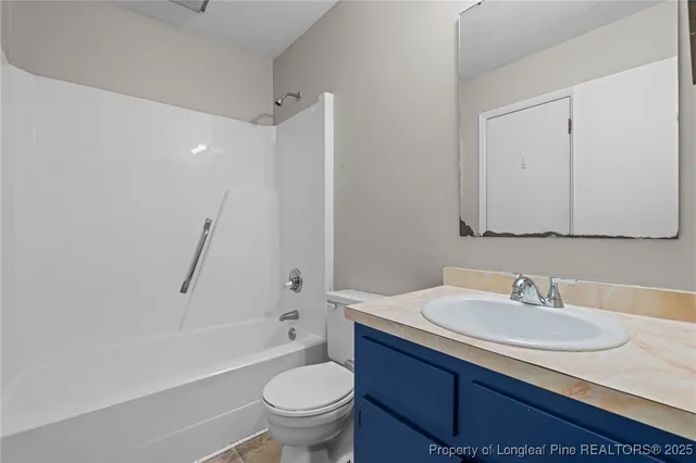 a bathroom with a sink toilet and a mirror