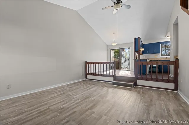a view of a room with a window and wooden floor