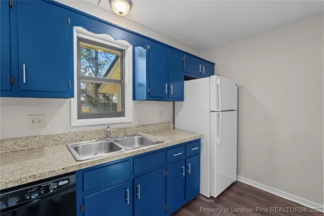 a kitchen with a sink appliances and cabinets