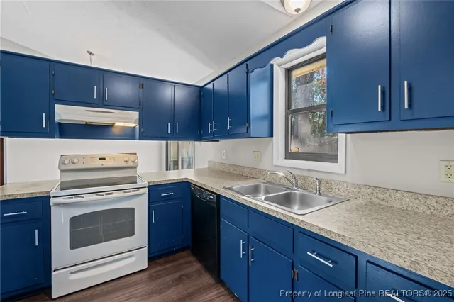 a kitchen with a sink stove and cabinets
