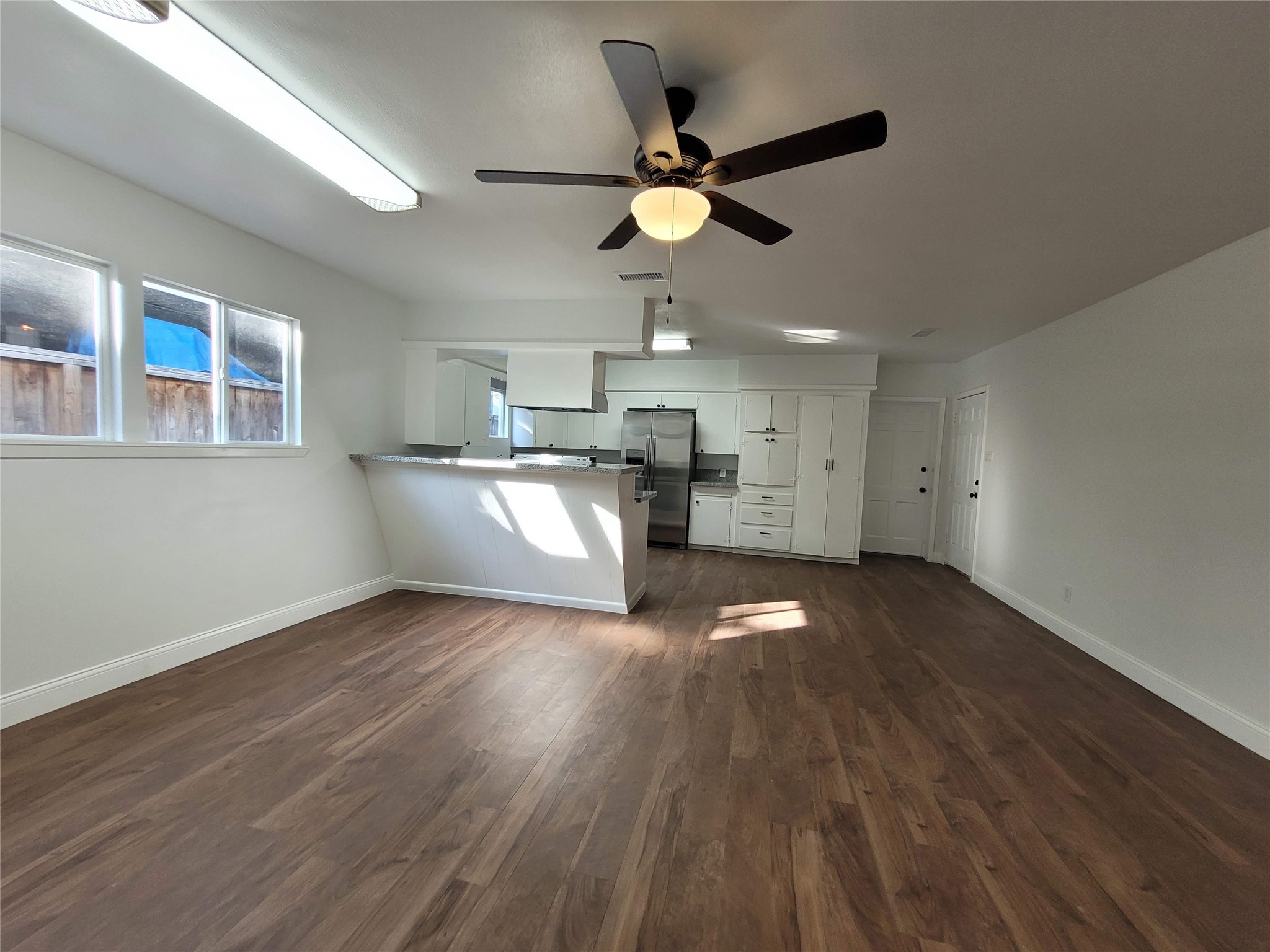 4302 Dickson Street Houston, TX 77007 - Photo 11 of 21 a view of a kitchen with a sink a ceiling fan and stainless steel appliances