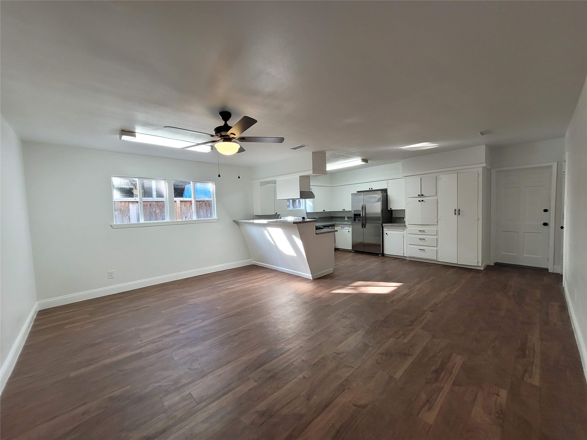 4302 Dickson Street Houston, TX 77007 - Photo 12 of 21 a view of an empty room with kitchen and window
