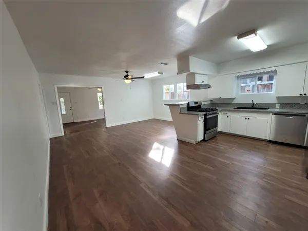 a kitchen with a stove a refrigerator and a sink