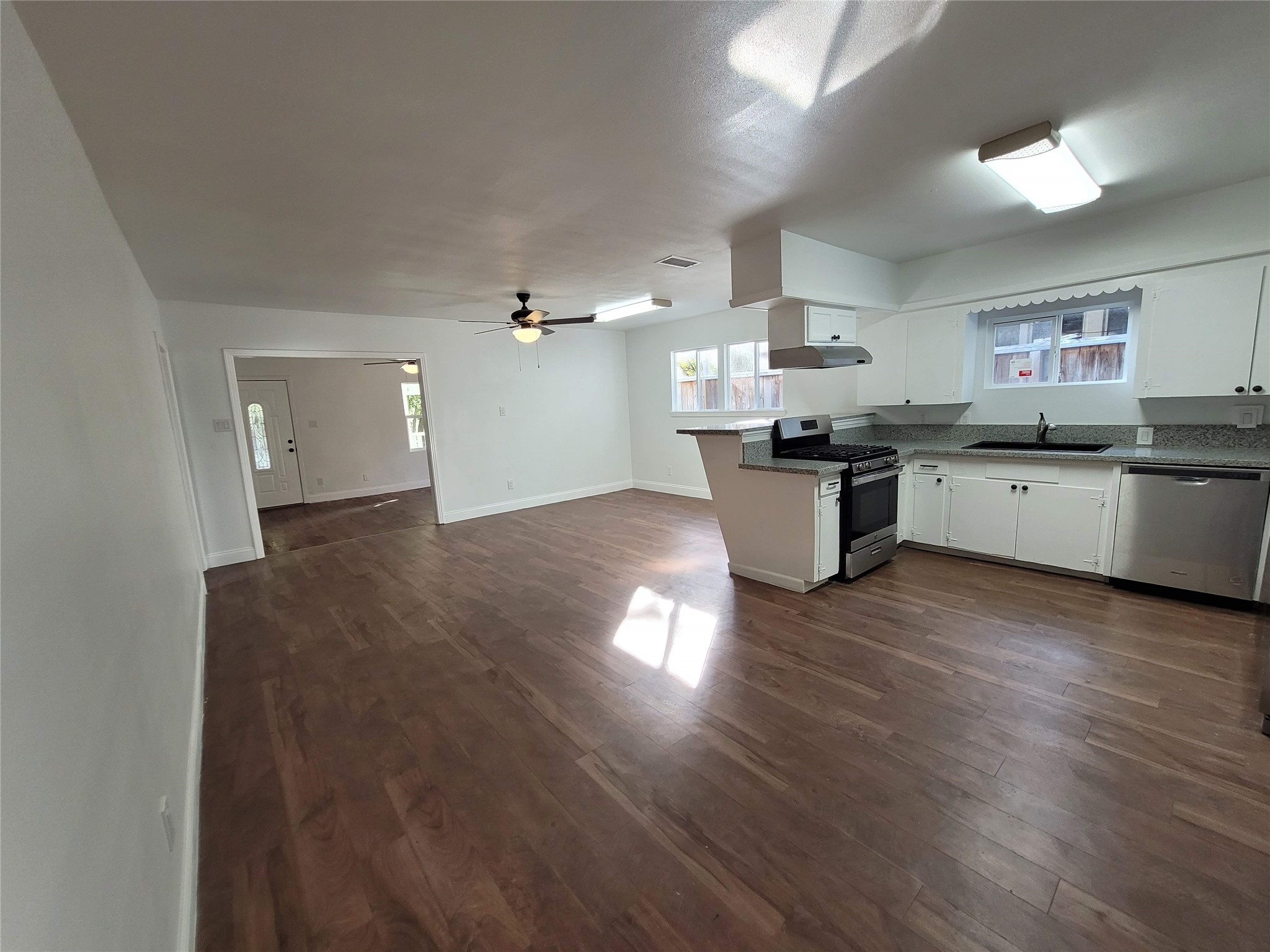 4302 Dickson Street Houston, TX 77007 - Photo 13 of 21 a kitchen with stove and wooden floor
