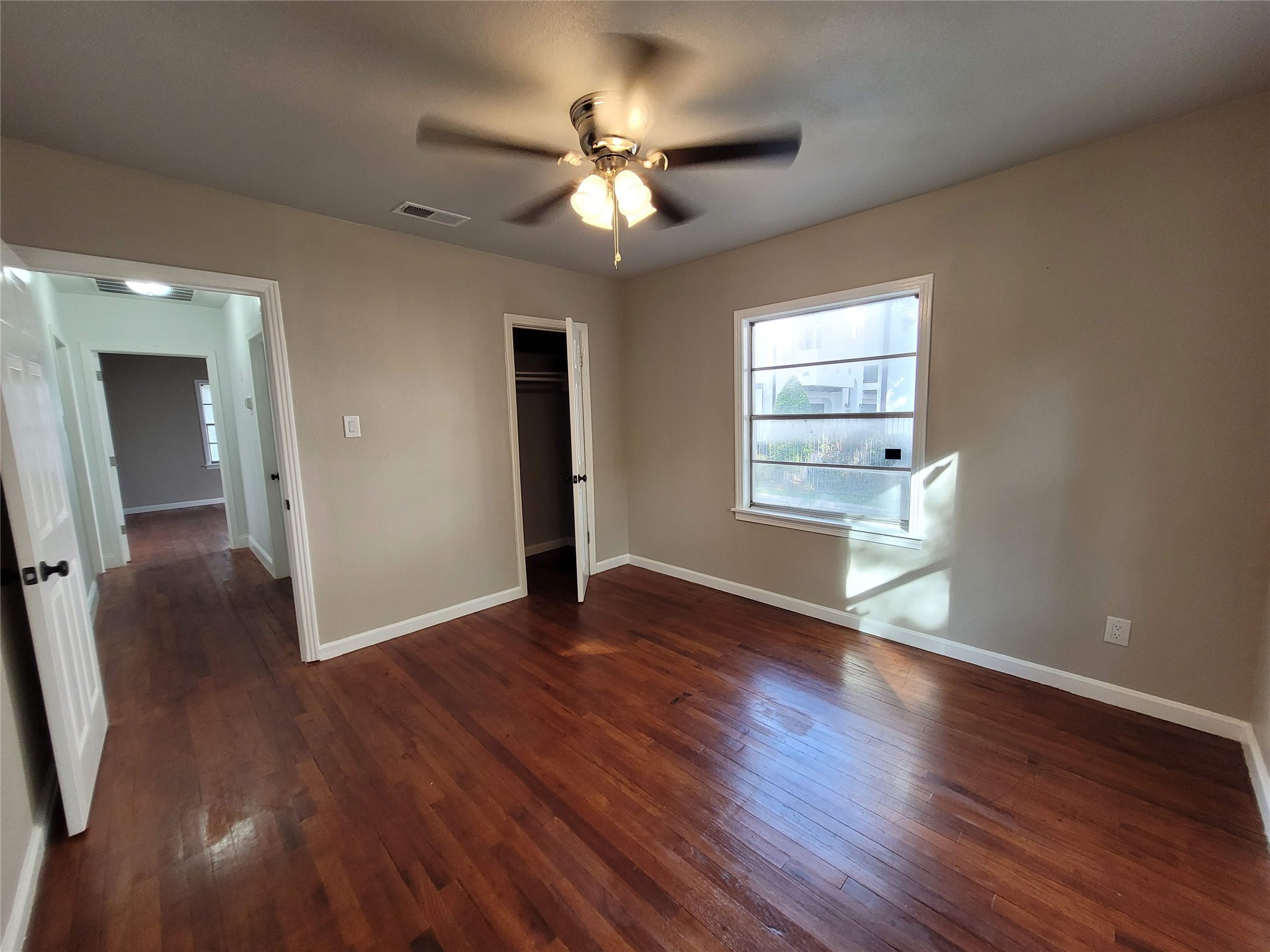4302 Dickson Street Houston, TX 77007 - Photo 18 of 21 a view of an empty room with wooden floor and a window