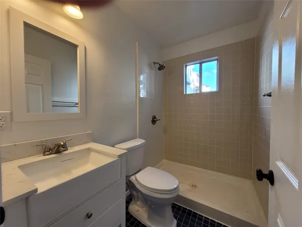 a bathroom with a toilet sink and a mirror
