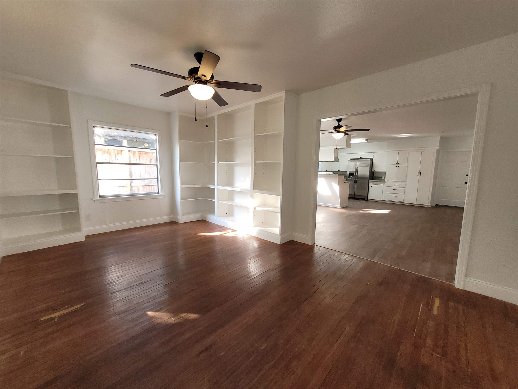 4302 Dickson Street Houston, TX 77007 - Photo 9 of 21 a view of an empty room with wooden floor and a window