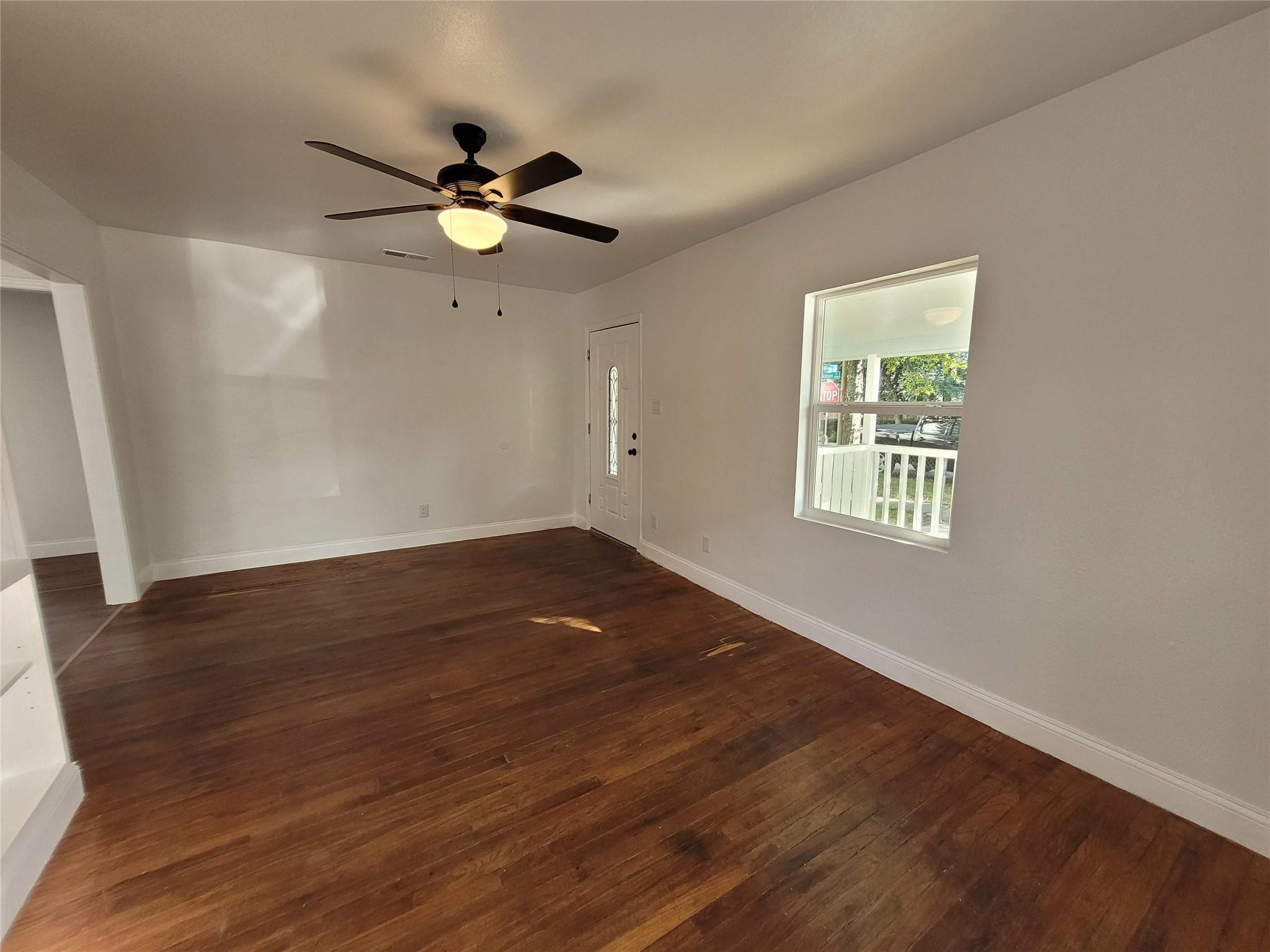 4302 Dickson Street Houston, TX 77007 - Photo 10 of 21 wooden floor in an empty room with a window