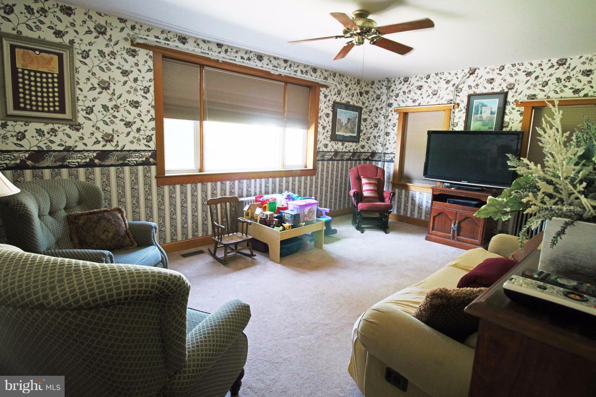 12949 Detour Road Keymar, MD 21757 - Photo 8 of 30 a living room with furniture a flat screen tv and a window