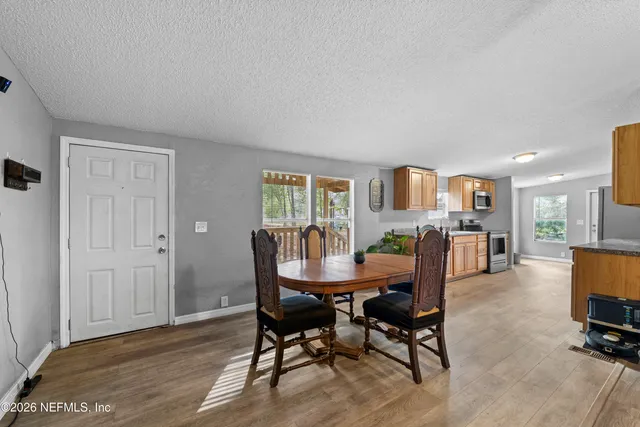 a dining room with furniture and window