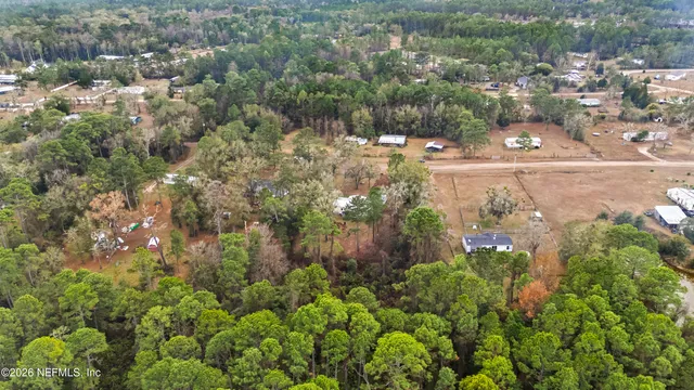 an aerial view of residential houses with yard and mountain view