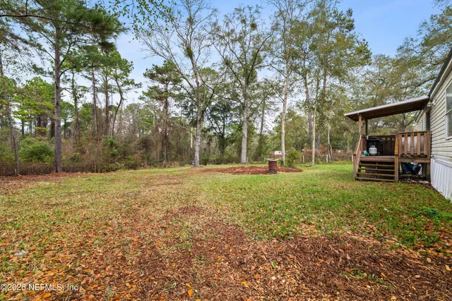 a front view of a house with a yard and sitting area
