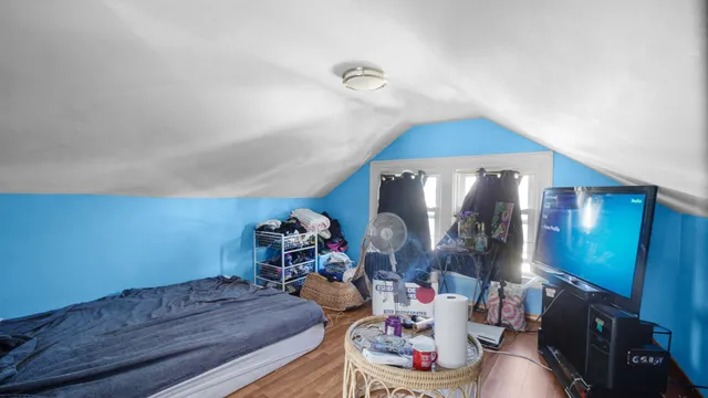 a bedroom with furniture and wooden floor