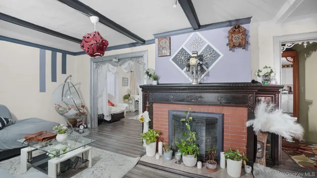a view of a livingroom with furniture a rug and a clock